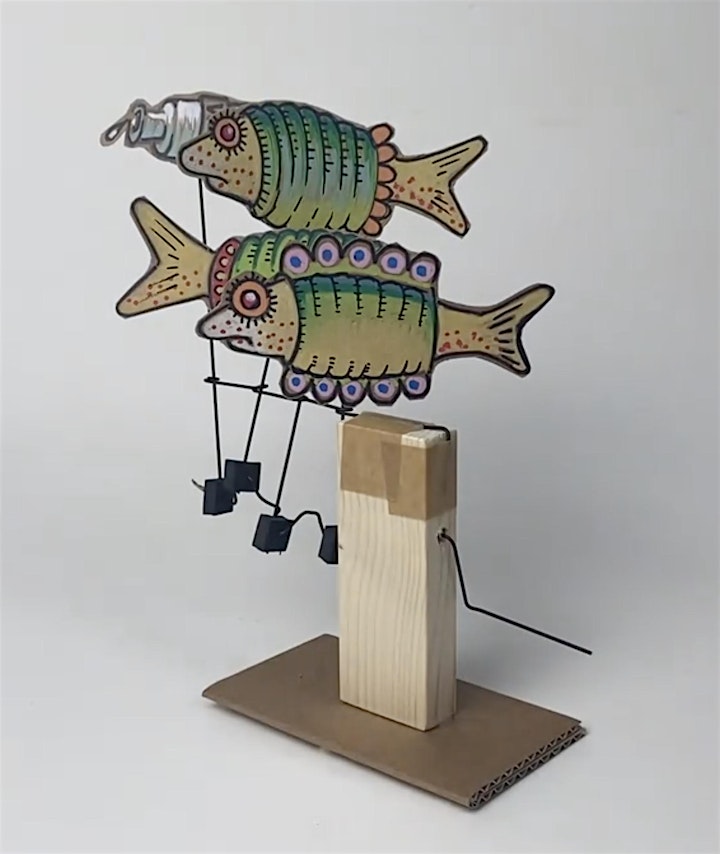 Painted cardboard fish in frocks on a wire crank