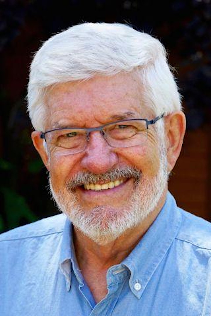 Headshot of man with white hair and glasses. 