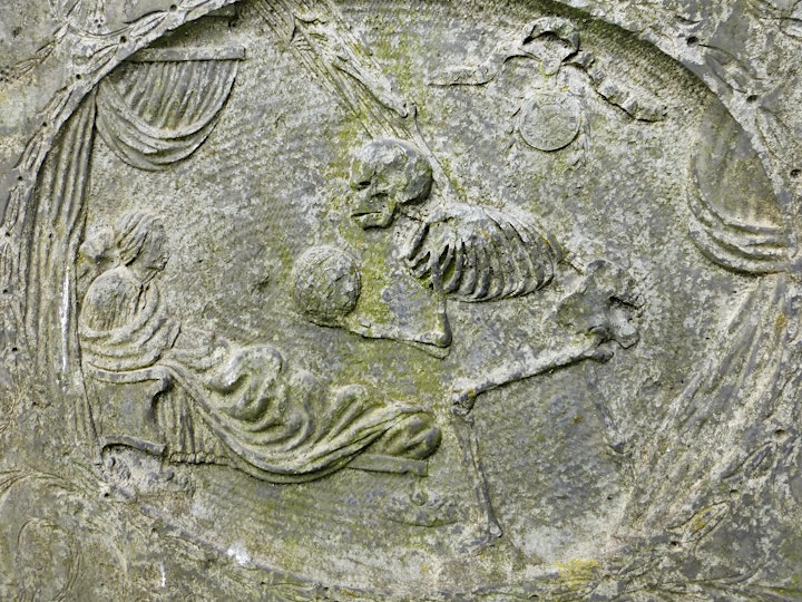 
		Death in the Churchyard: Skeletons, skulls and bones on slate tombstones image
