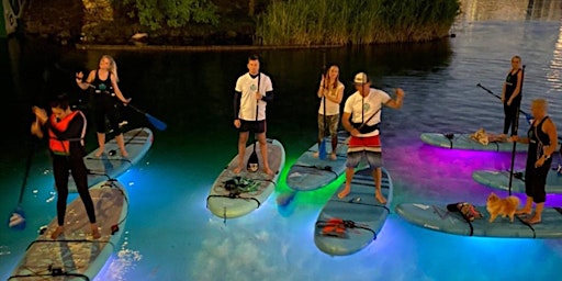Stand up paddling by night with light.
